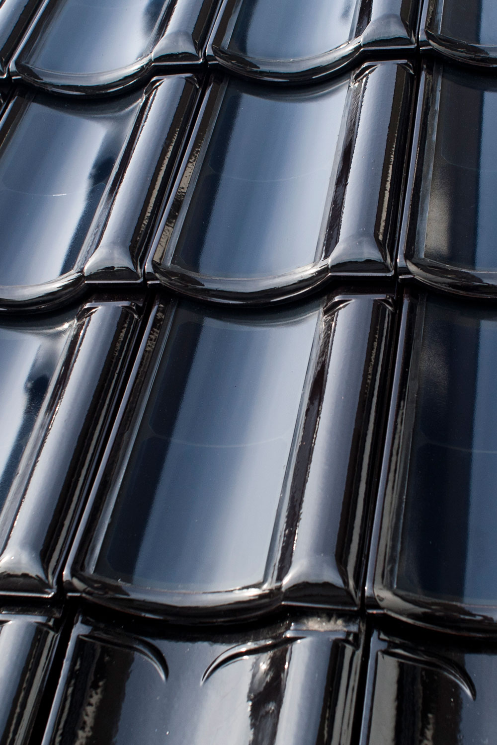 FlexSol solar PV roof tile - BiPV or building integrated PV in the form of a ceramic curved roof tile with flexible PV cells